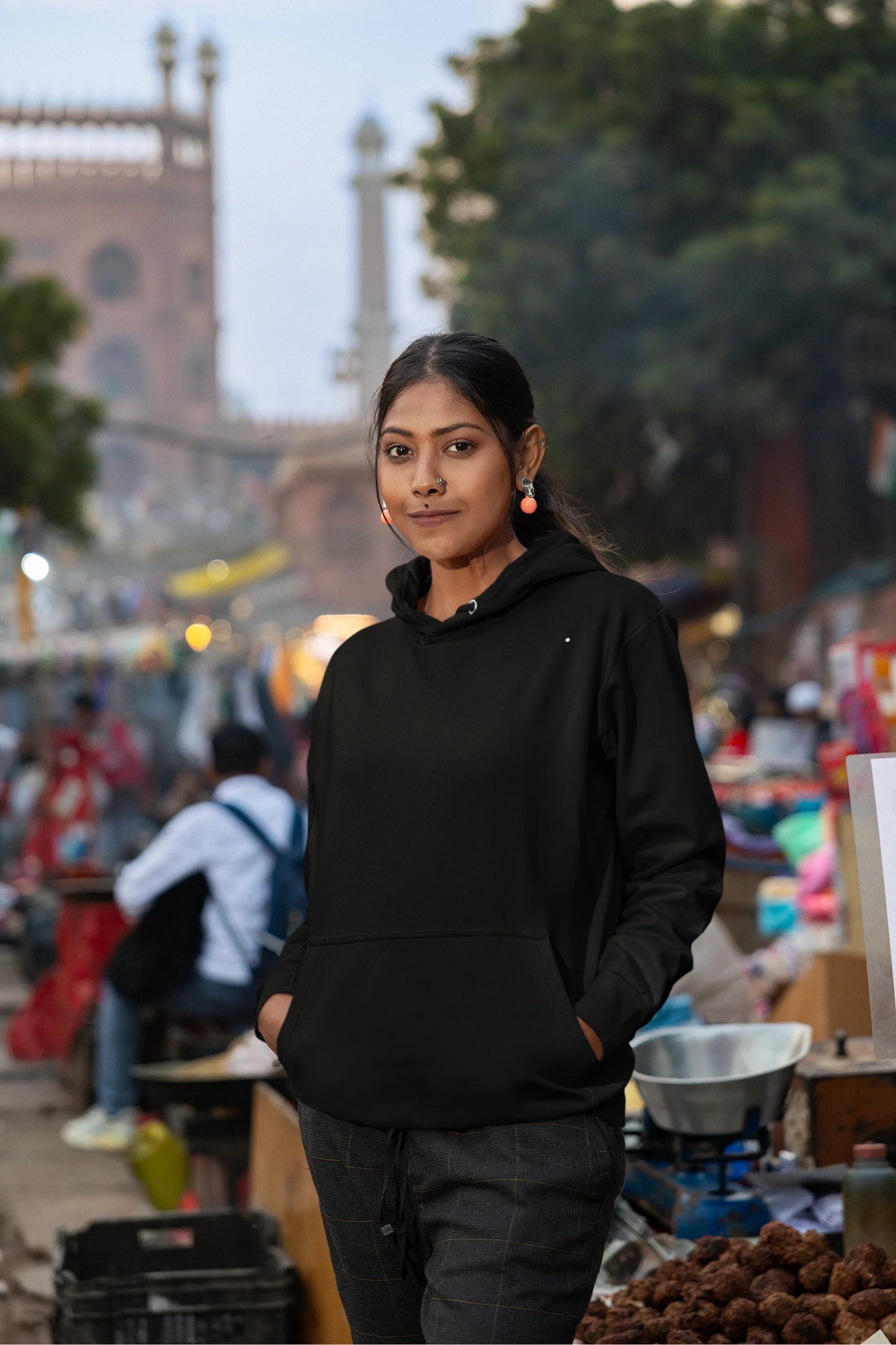 Fifth front view of a female model wearing a black hoodie with a Japanese art style tiger design.