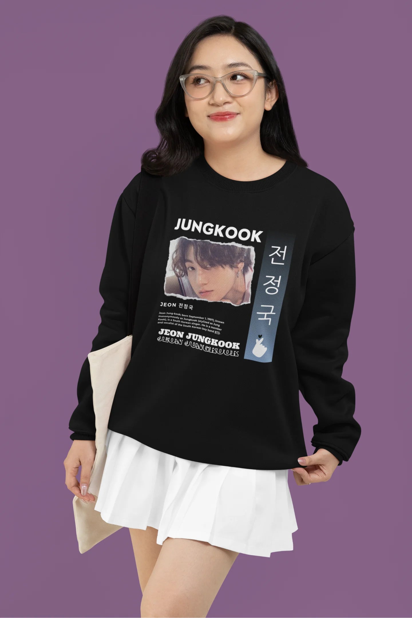 Fourth front view of a female model wearing a black sweatshirt featuring a vibrant design inspired by BTS member Jungkook. Ideal for fans of BTS and K-Pop music in general.