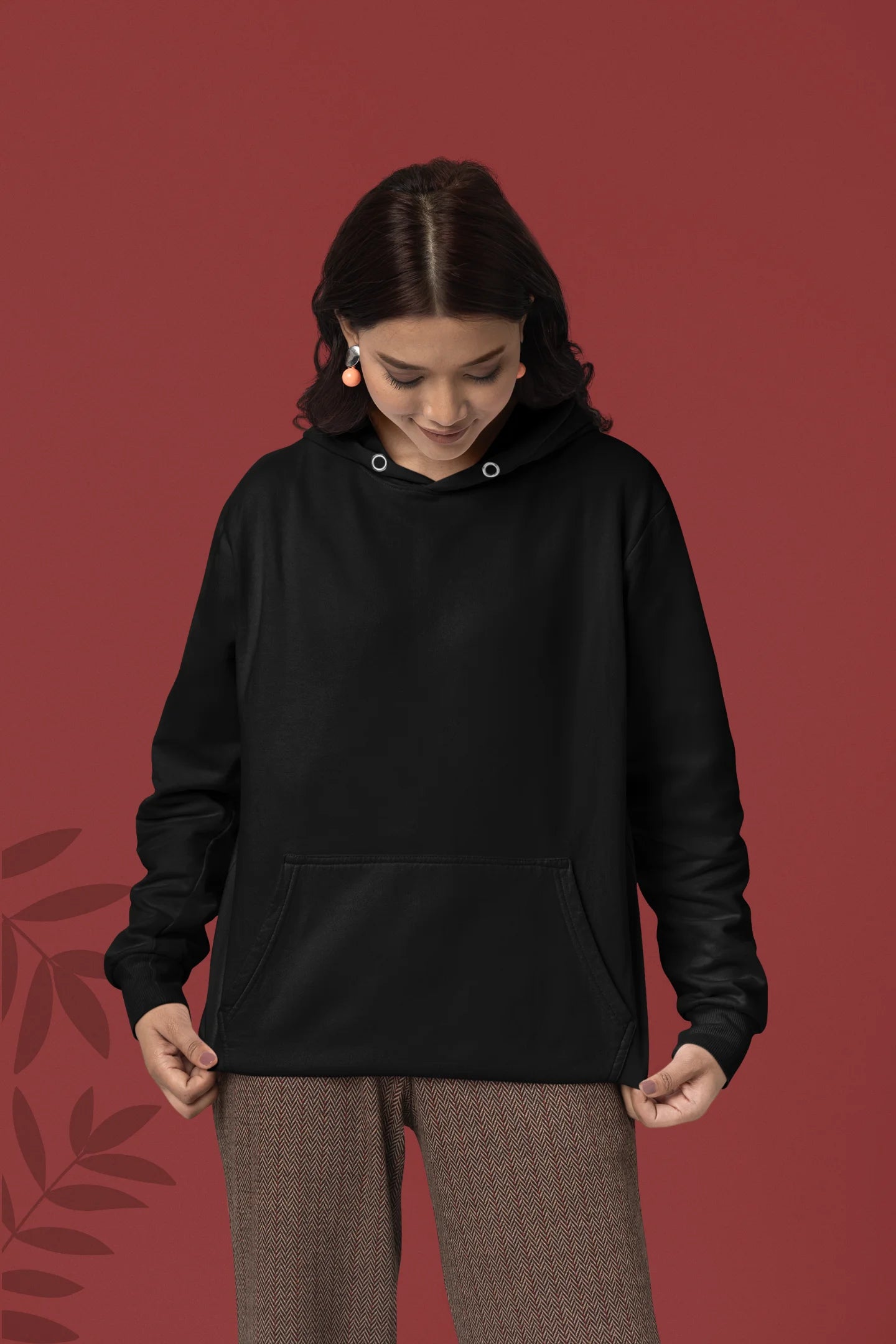 First front view of a female model wearing a black hoodie with a heron taking off under the moonlight.