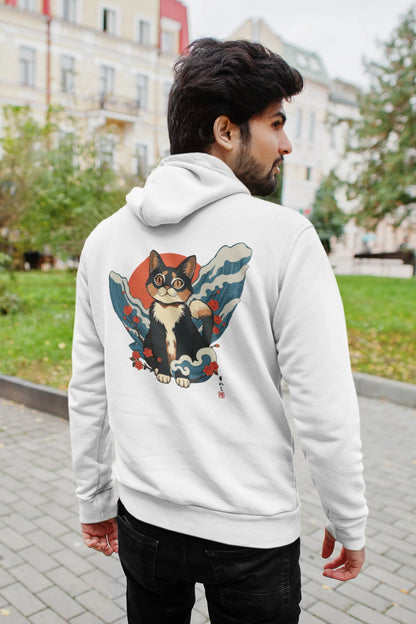 Back view of a male model wearing a white hoodie with a design of a cat dressed as a samurai, standing against a backdrop of waves and a rising sun.