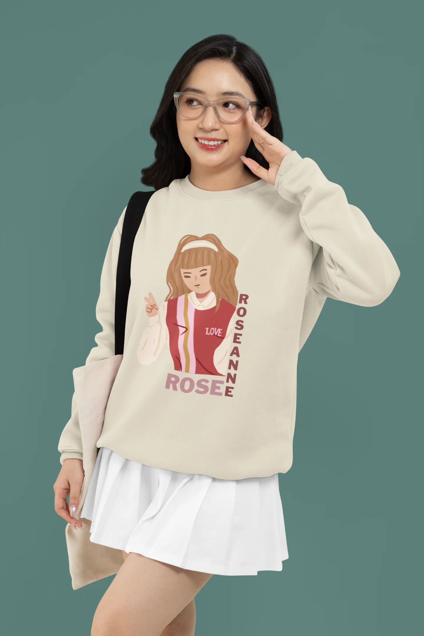 First front view of a female model wearing a cream sweatshirt featuring a stylish design inspired by Blackpink member Rosé. Ideal for fans of Rosé, Blackpink, and K-Pop music enthusiasts.