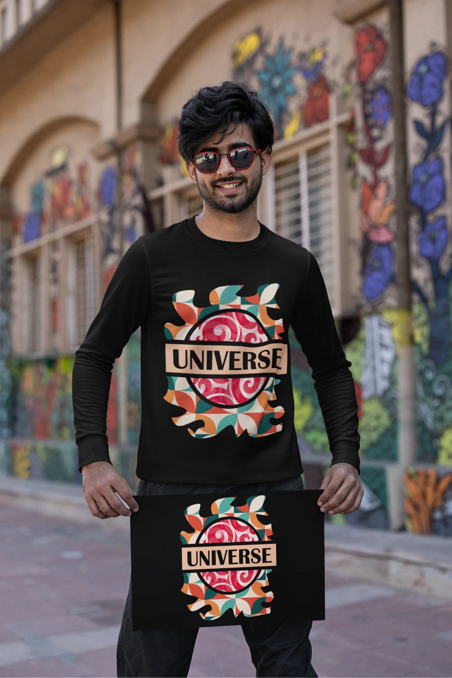 Third front view of a male model wearing an black sweatshirt with a cosmic Universe design inspired by Coldplay.