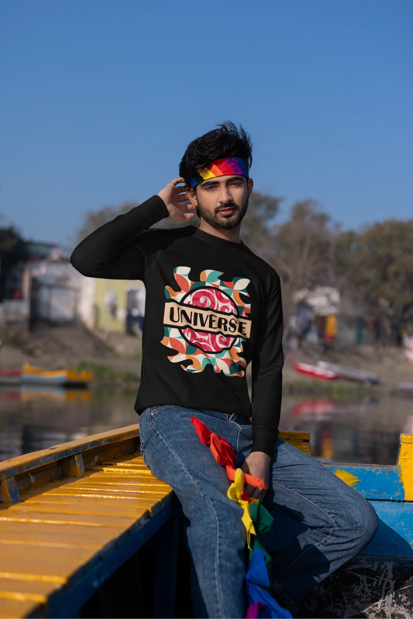 Second front view of a male model wearing an black sweatshirt with a cosmic Universe design inspired by Coldplay.