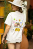 Back view of a female model wearing an oversized off-white t-shirt with a positive message 