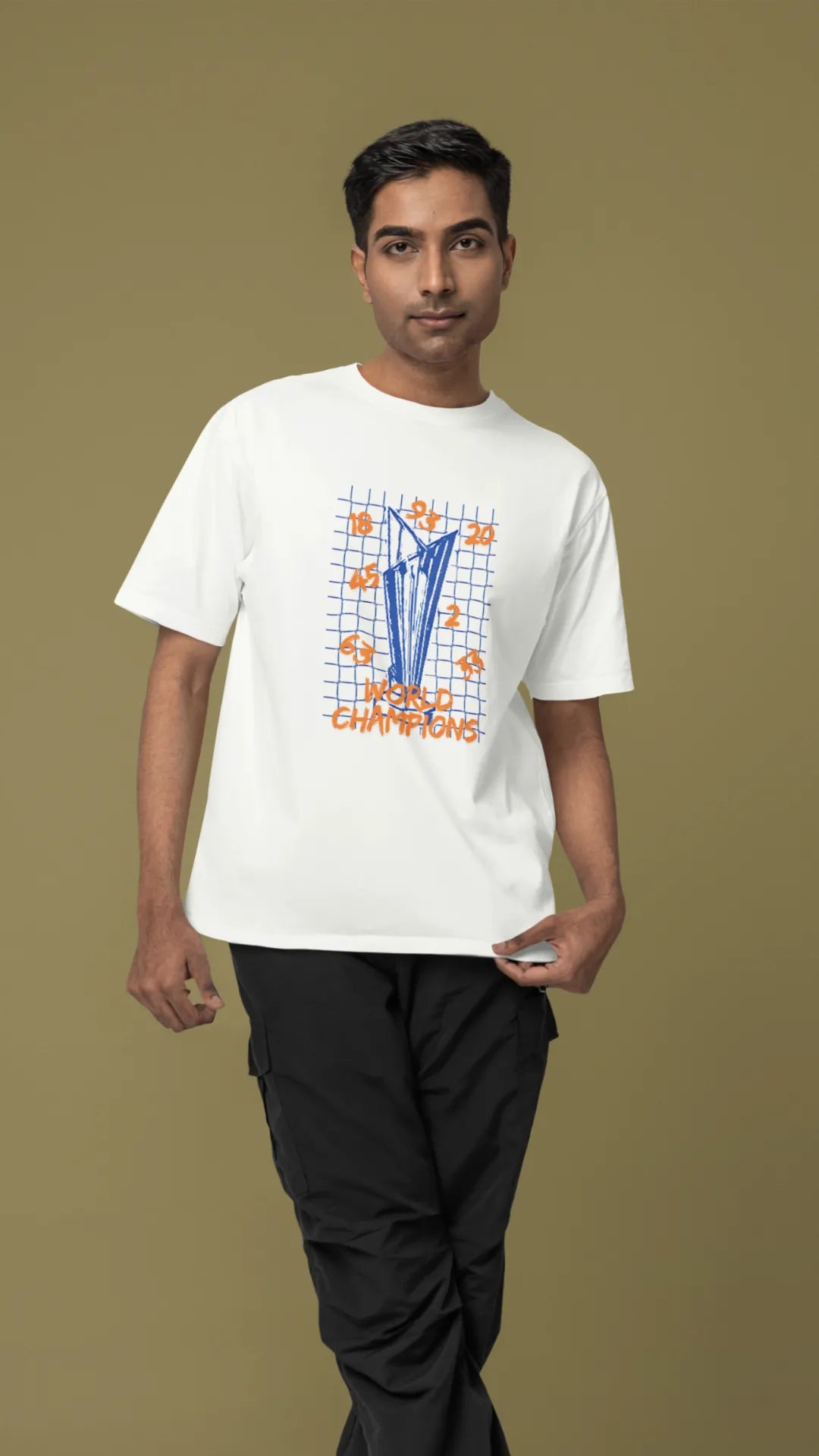 Third front image of male model wearing an off-white oversized t-shirt featuring the World Cup 2024 trophy with the text "World Champions" underneath. Ideal for Indian cricket fans celebrating their team's victory.