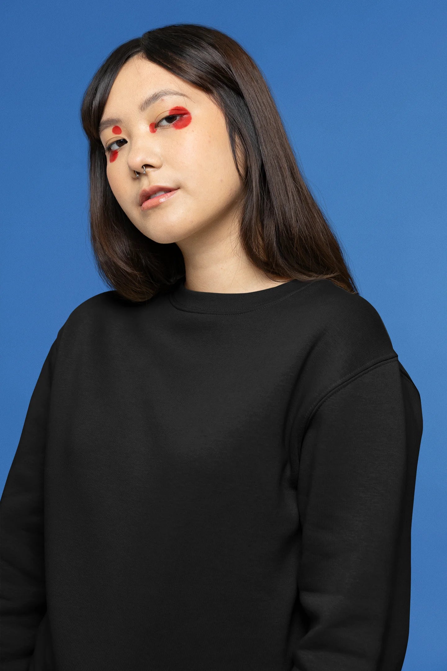 Second front view female model wearing a black sweatshirt with a design of a fox and its cub in a traditional Japanese landscape.