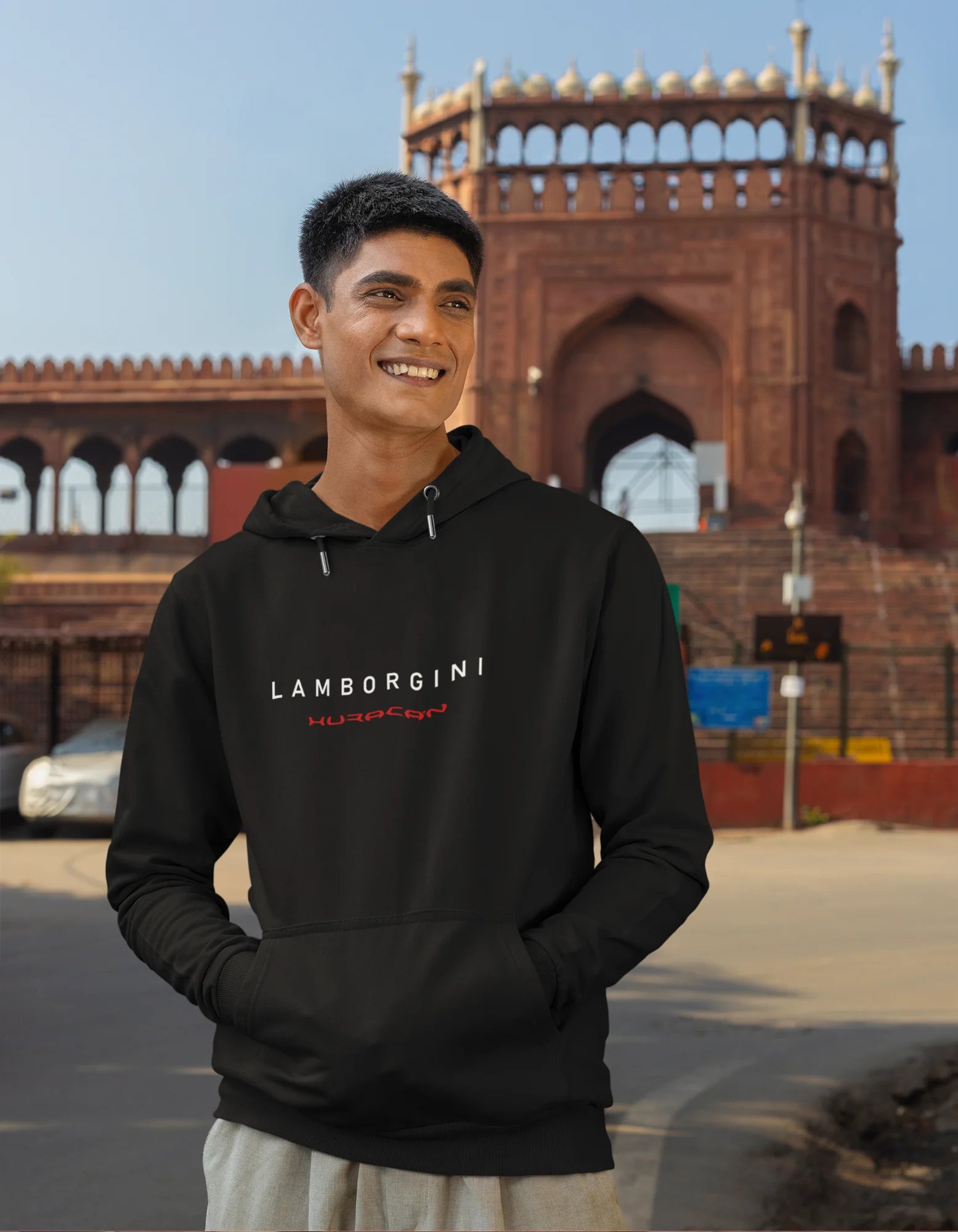 Second front view of a male model wearing a black hoodie featuring a Lamborghini Huracan design, exuding speed and power.