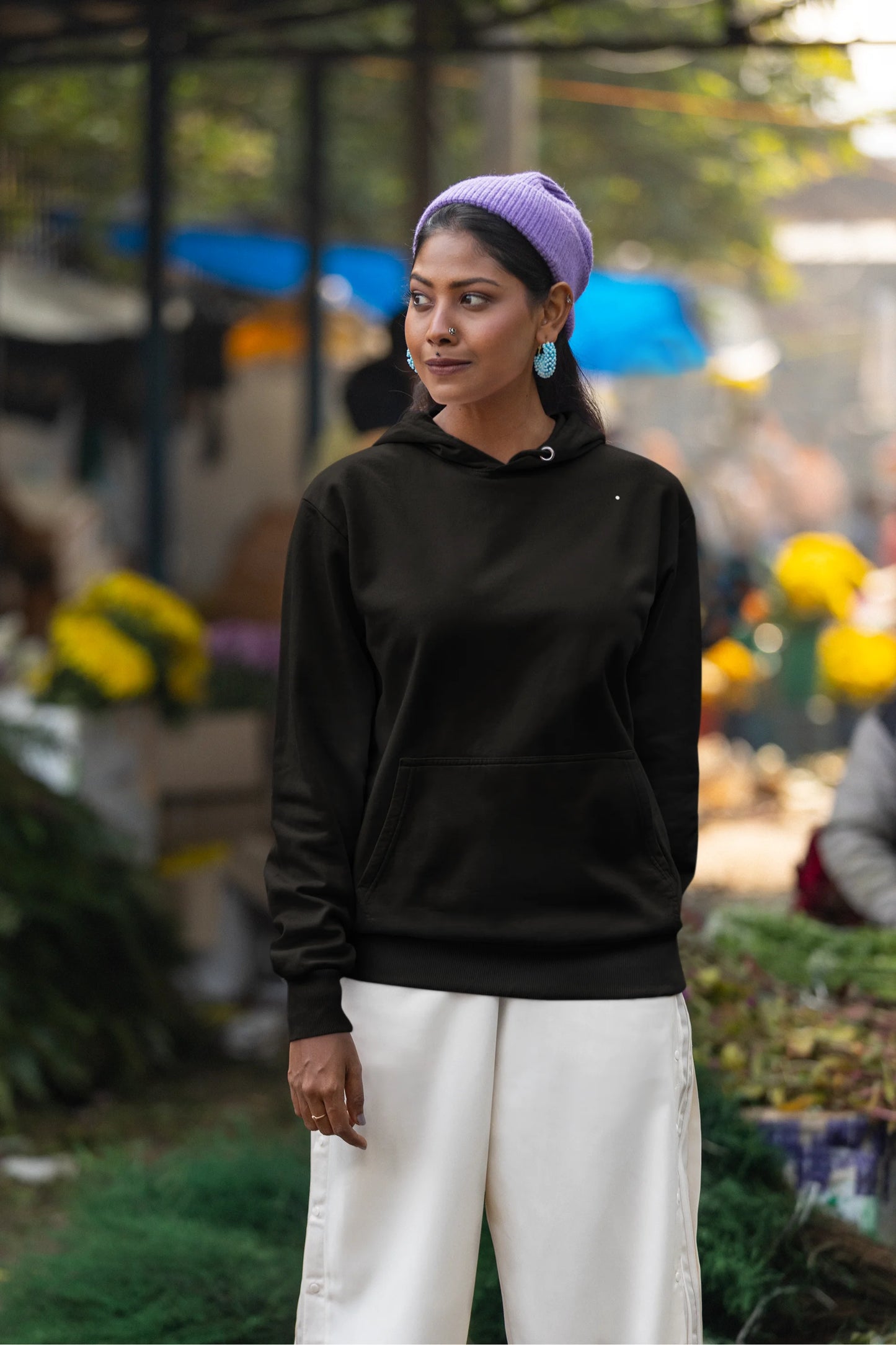 Fourth front view of a female model wearing a black hoodie with a Japanese art style tiger design.