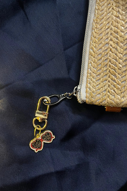 Second view of a keychain featuring a design inspired by Taylor Swift's "Evermore" album. Perfect for all swifties.