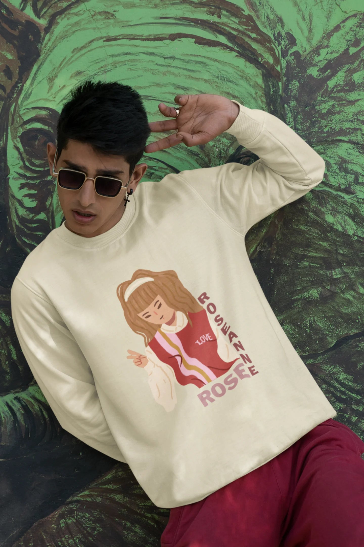 Third front view of a male model wearing a cream sweatshirt featuring a stylish design inspired by Blackpink member Rosé. Ideal for fans of Rosé, Blackpink, and K-Pop music enthusiasts.