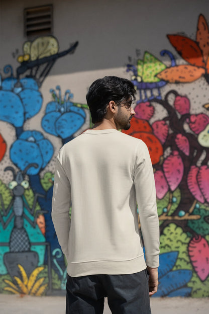 Back view of a male model wearing an cream sweatshirt with a cosmic Universe design inspired by Coldplay.