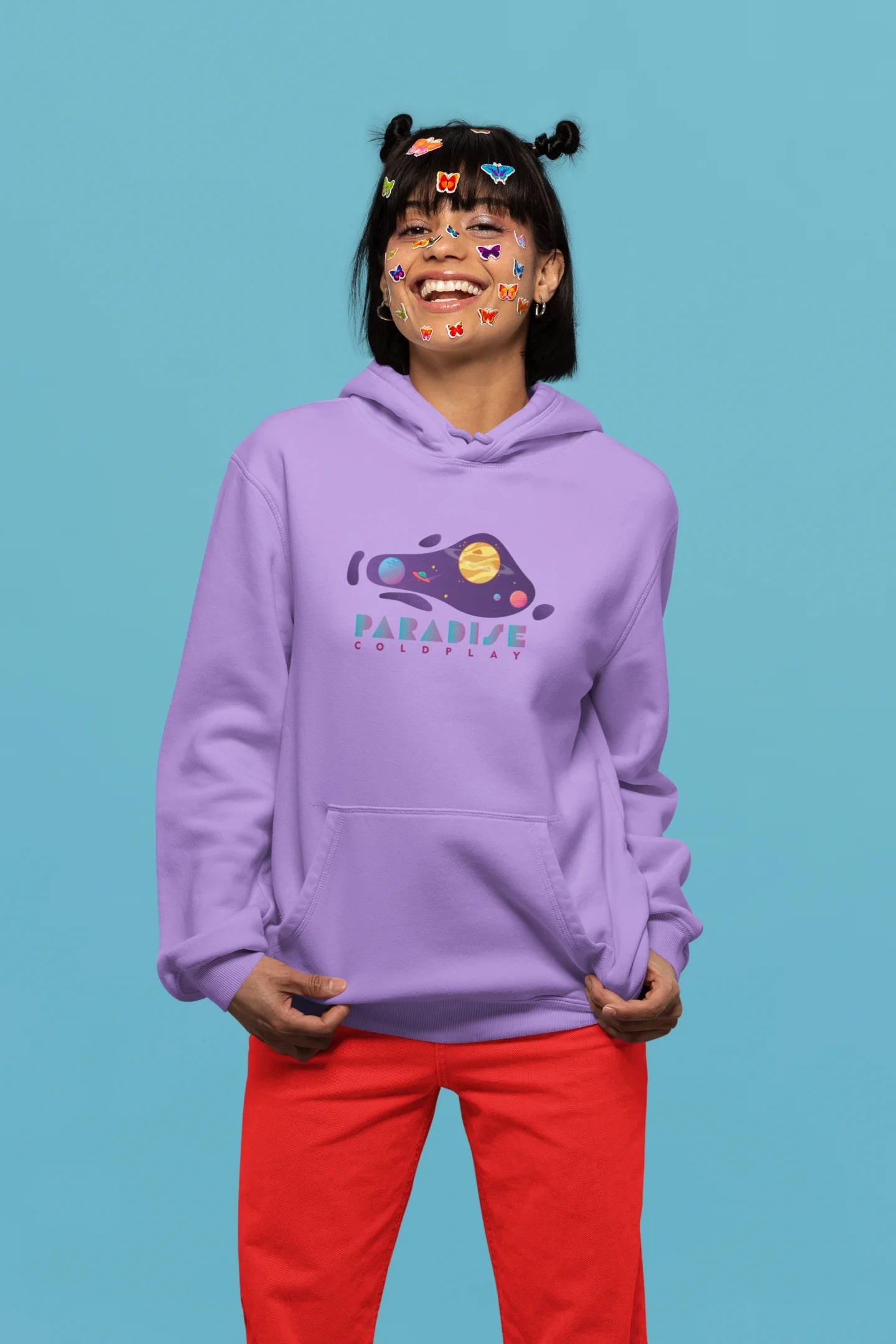 4th front view of a female model wearing an lavender hoodie with the "Paradise" album artwork by Coldplay.