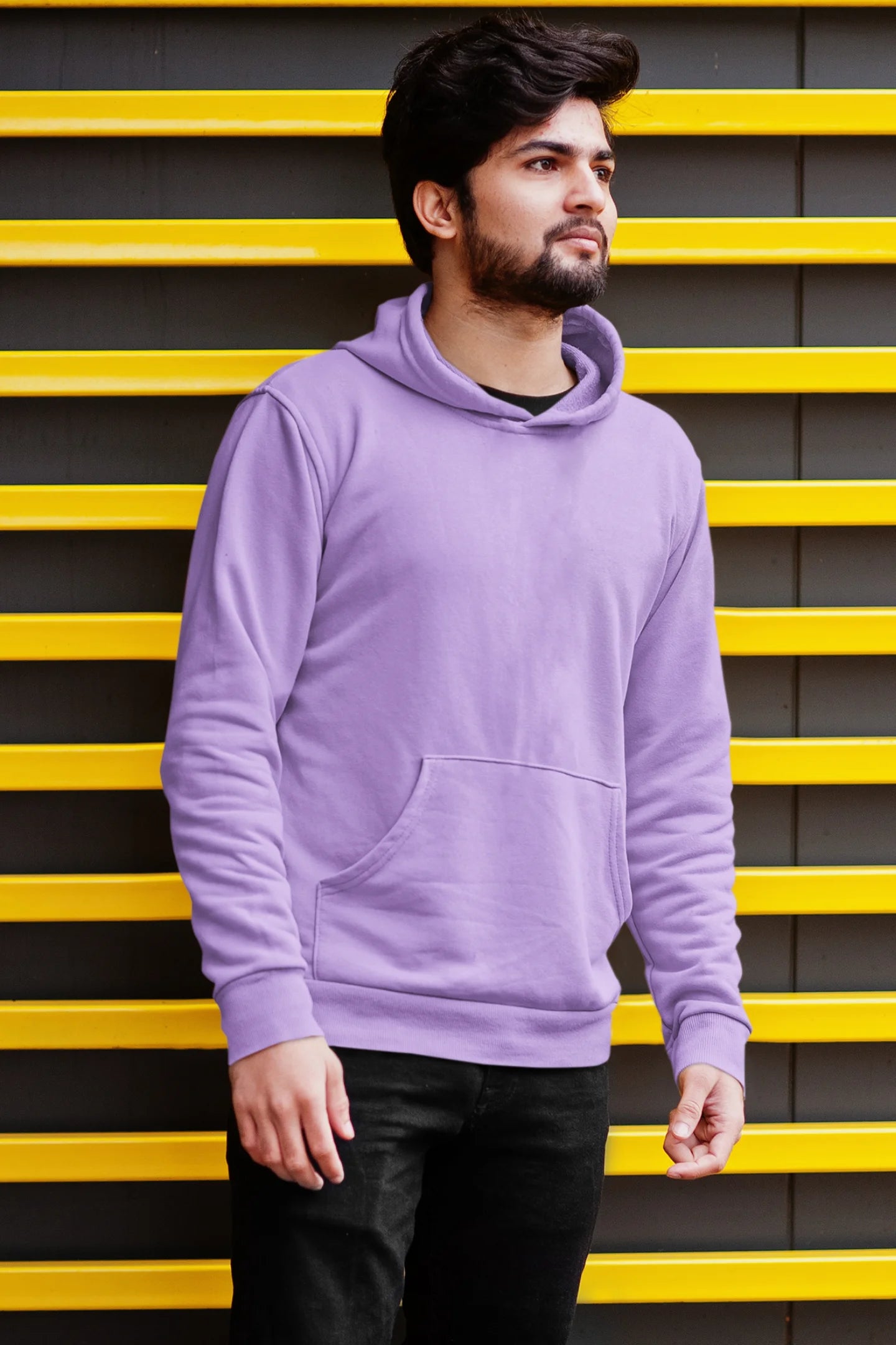 First front view of a male model wearing a lavender hoodie with a design of a cat dressed as a samurai, standing against a backdrop of waves and a rising sun.