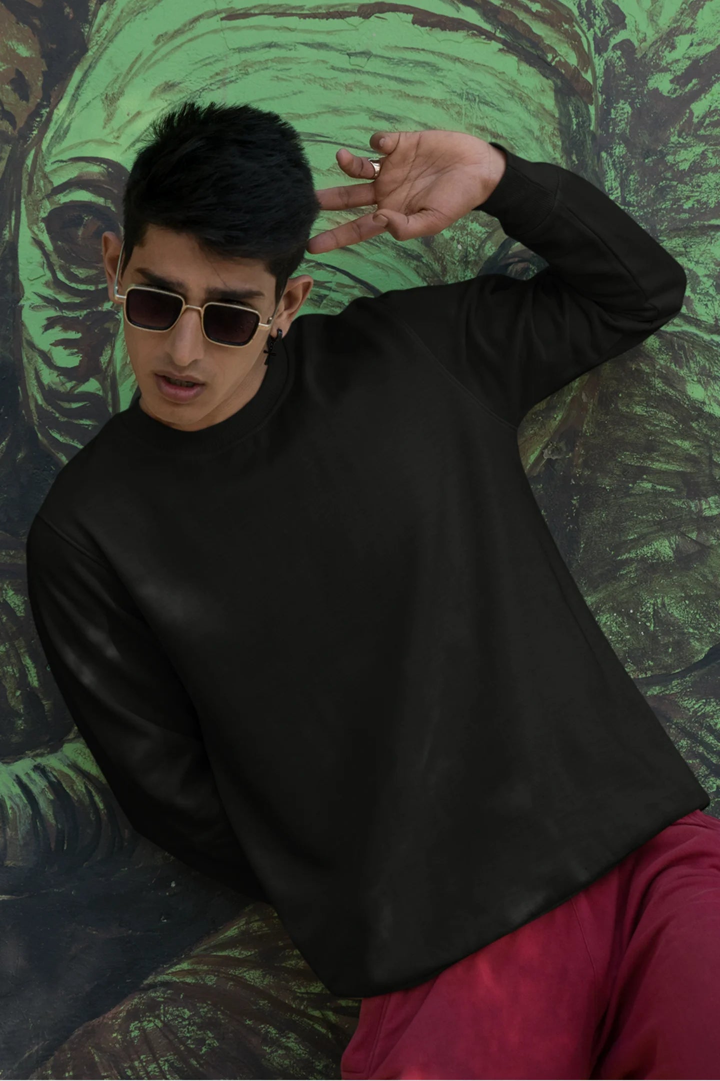 Third front view of a male model wearing a black sweatshirt featuring a stylish design inspired by Blackpink member Jisoo. Ideal for Blinks (Blackpink fans) and K-Pop enthusiasts who love Korean music and fashion.