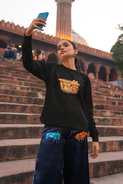 3rd front view of a female model wearing a black oversized t-shirt with the phrase "Party Hard" in an energetic Hindi.