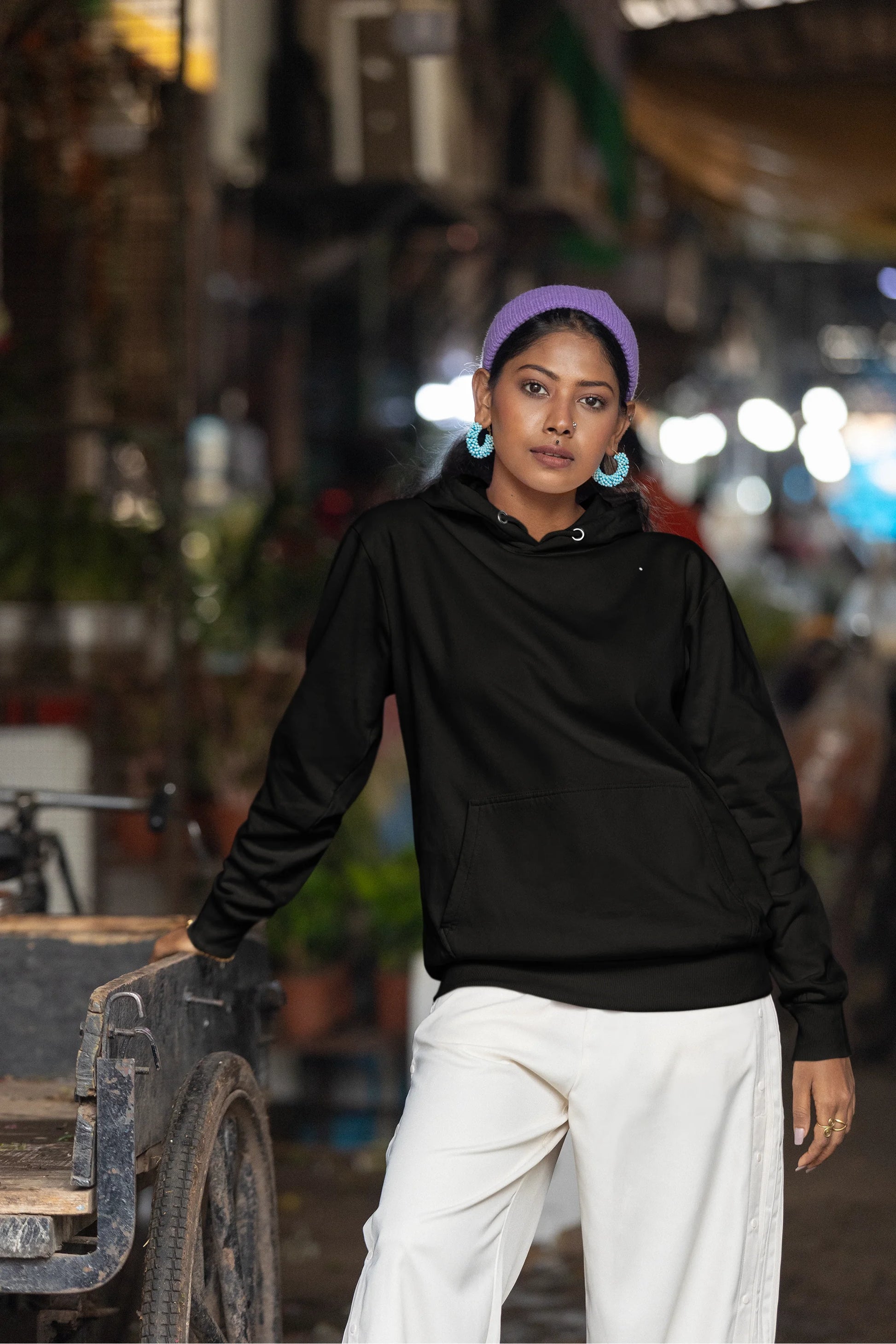 First front view of a female model wearing a black hoodie with a Japanese art style tiger design.