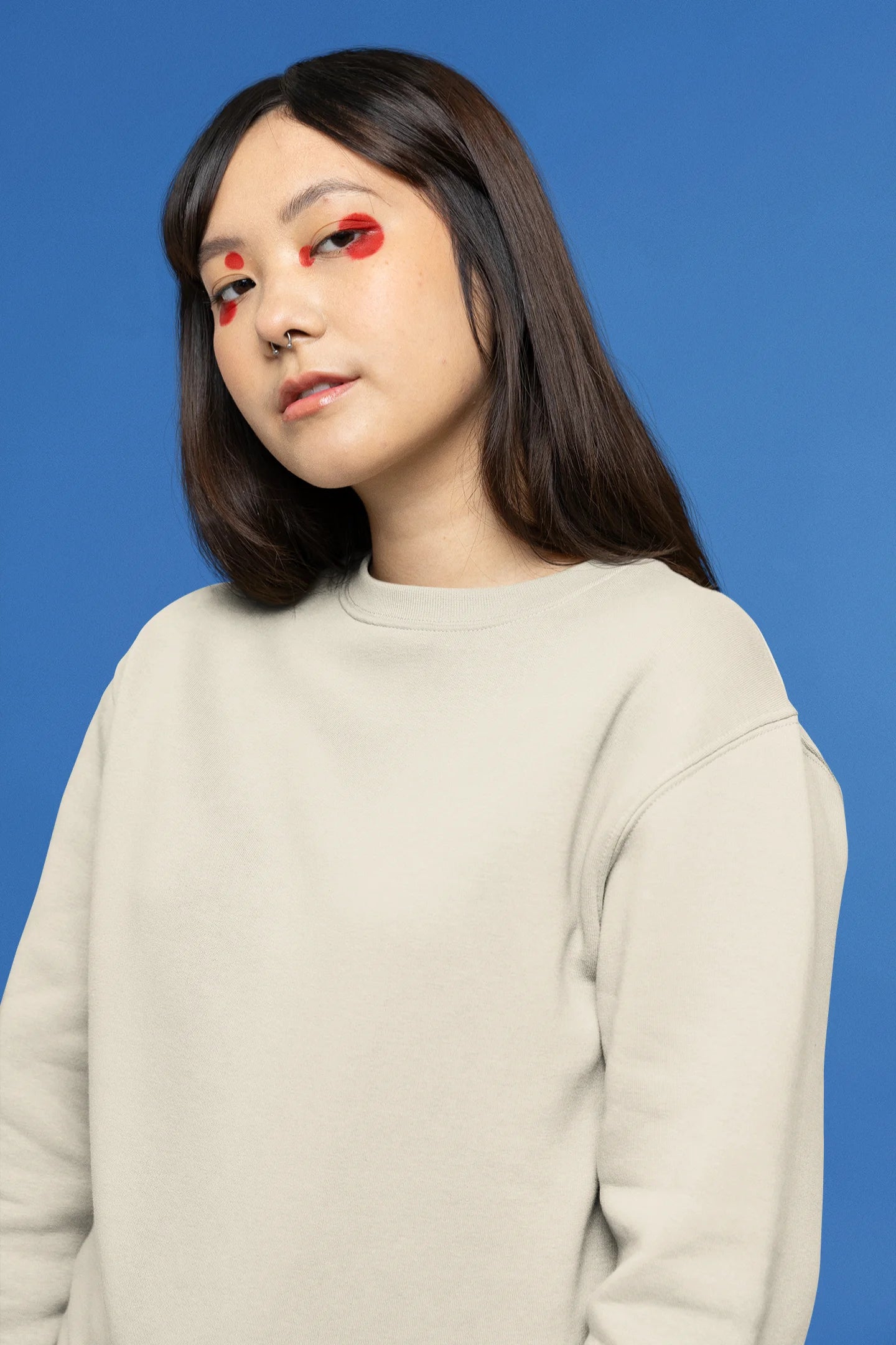 First front view female model wearing a cream sweatshirt with a design of a fox and its cub in a traditional Japanese landscape.