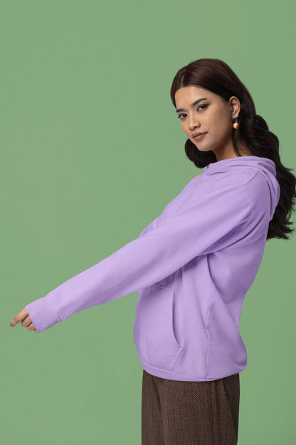 Third front view of female model wearing a lavender hoodie with a design of a cat dressed as a samurai, standing against a backdrop of waves and a rising sun.