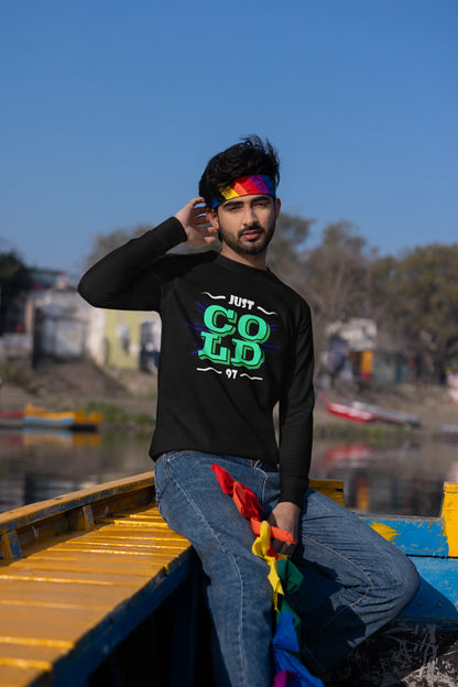 Third front view of a male model wearing an black sweatshirt with the text "Just Cold" printed on it.
