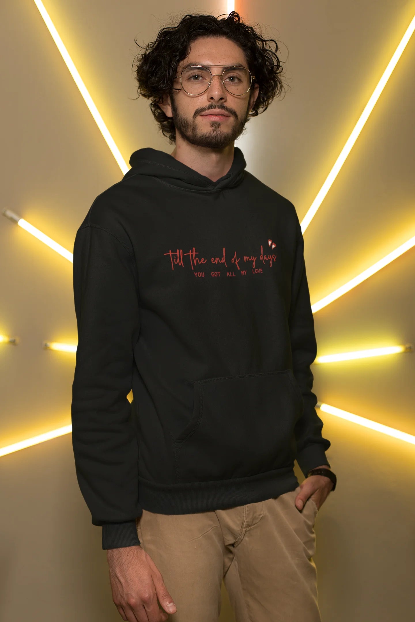 Third front view of a male model wearing a black hoodie with a heart design and the text "All My Love".