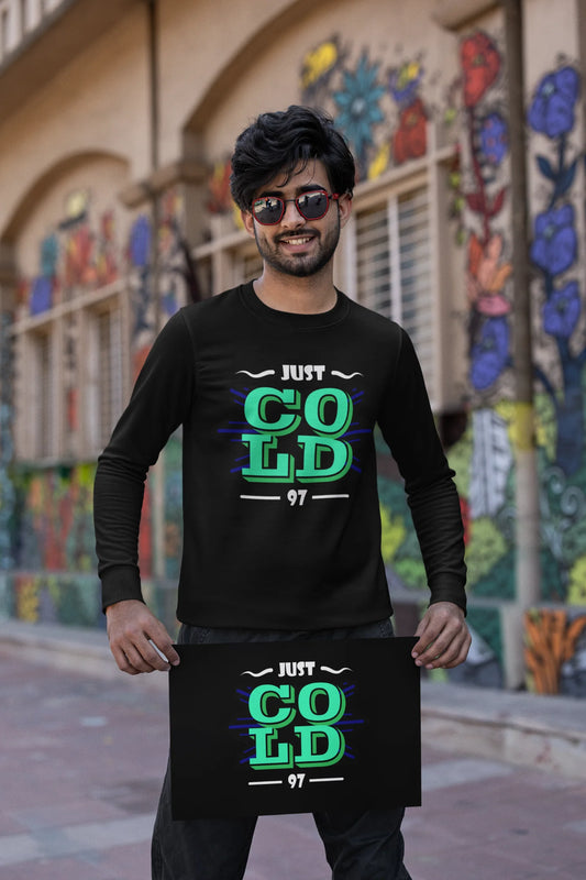First front view of a male model wearing an black sweatshirt with the text "Just Cold" printed on it.