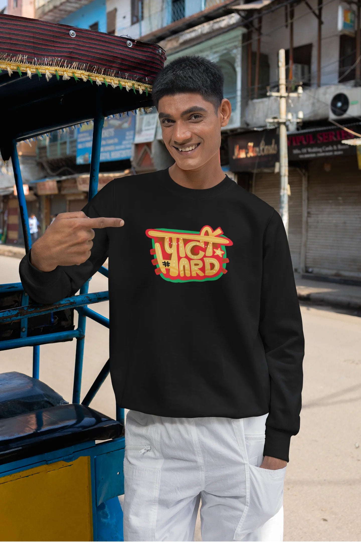 2nd front view of a male model wearing a black oversized t-shirt with the phrase "Party Hard" in an energetic Hindi.