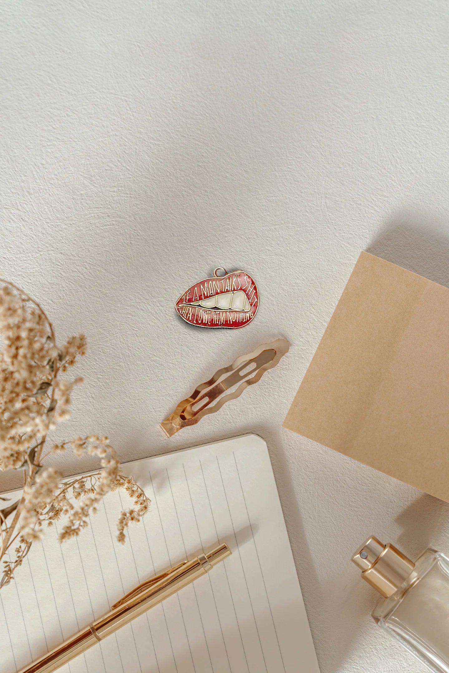 Fourth image of an charm featuring the Taylor Swift phrase "You Owe Him Nothing" on a lip design. Perfect for all Swifties.