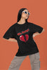 First front view of a female model wearing a black oversized t-shirt with the text 