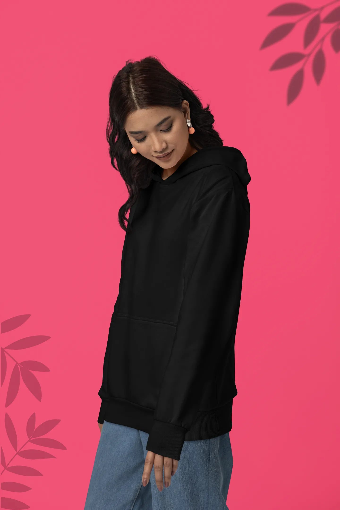 First front view of a female model wearing a black hoodie with a design of a wildcat sitting on ocean waves.