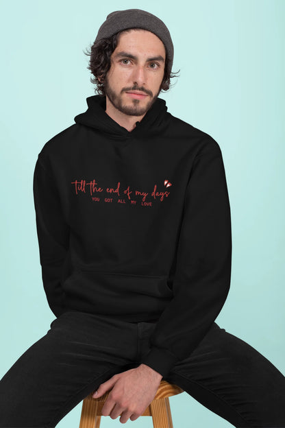 First front view of a male model wearing a black hoodie with a heart design and the text "All My Love".