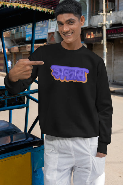 3rd front view of a male model wearing an black sweatshirt featuring "Jhakas" in a stylish font.