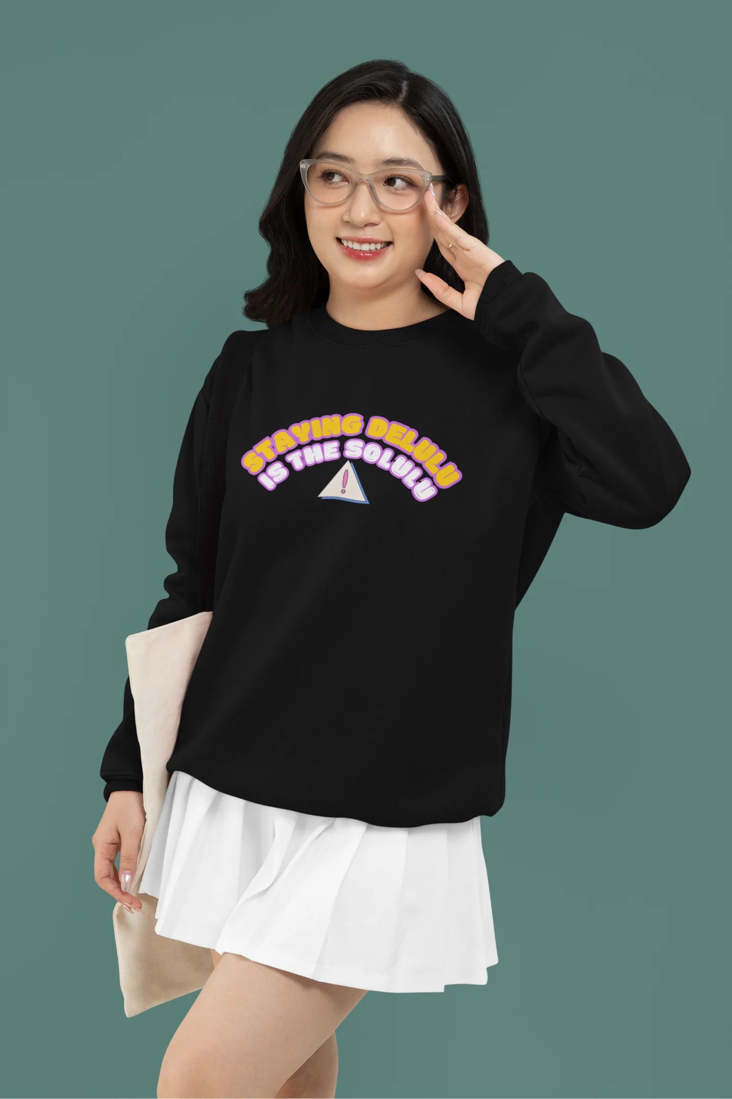 4th front view of female model wearing a black sweatshirt with the hilarious message "Stay Delulu" in a bold design. Ideal for those who love trendy slang and lighthearted humor.