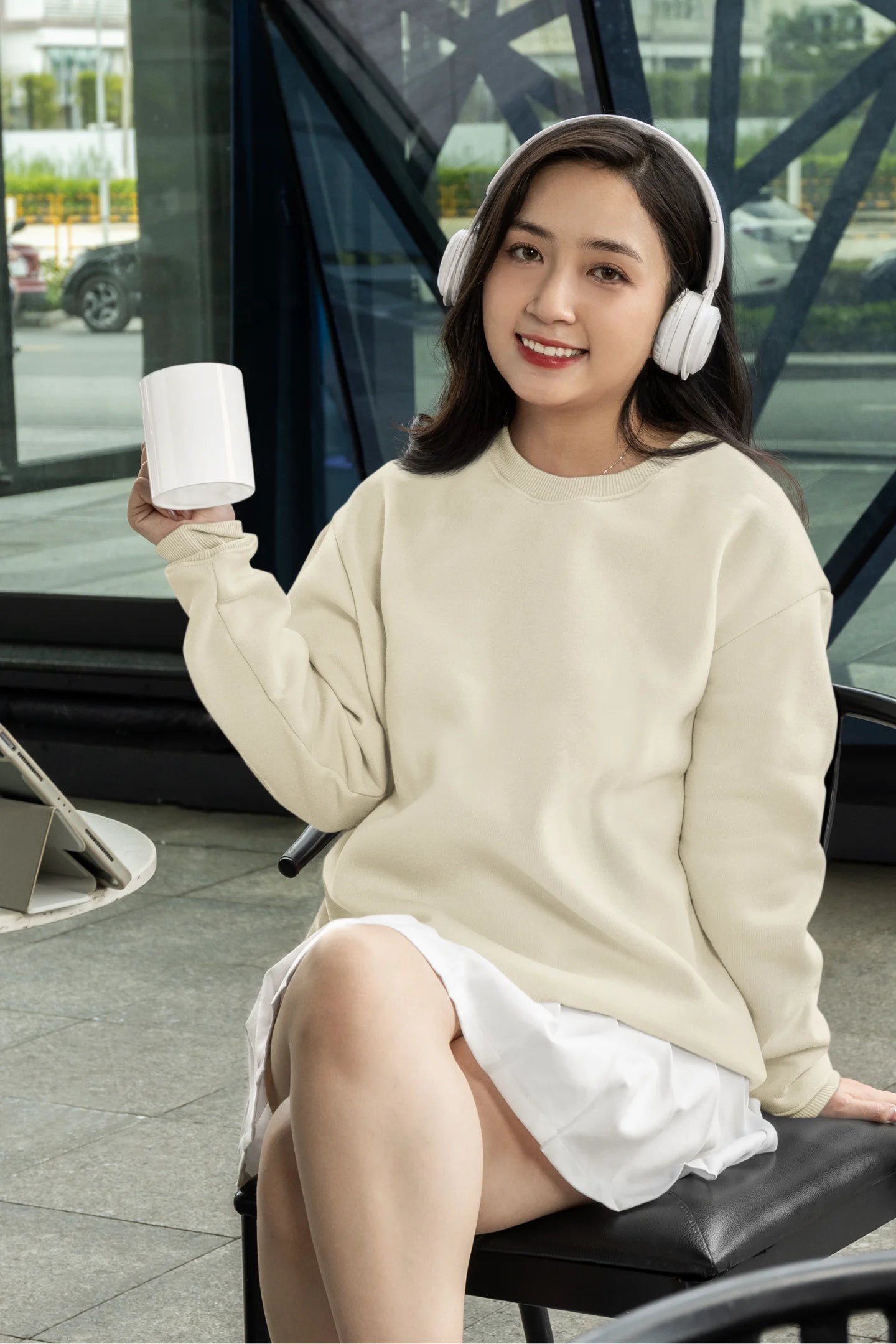 Fourth front view of female model wearing a cream F.R.I.E.N.D.S. sweatshirt featuring a design inspired by Joey Tribbiani's funny quotes and signature charm.