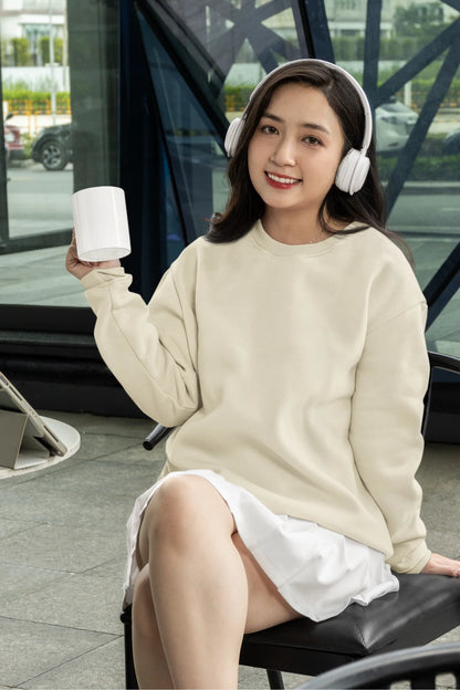 Fourth front view of female model wearing a cream F.R.I.E.N.D.S. sweatshirt featuring a design inspired by Joey Tribbiani's funny quotes and signature charm.
