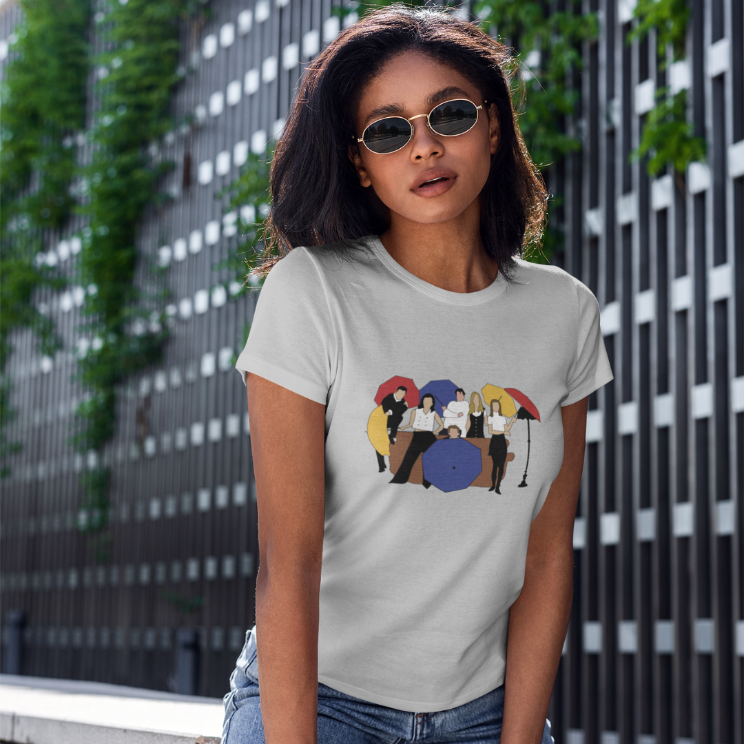 Female model wearing a grey regular-fit t-shirt featuring the iconic "I'll Be There For You" design from the F.R.I.E.N.D.S. TV series.