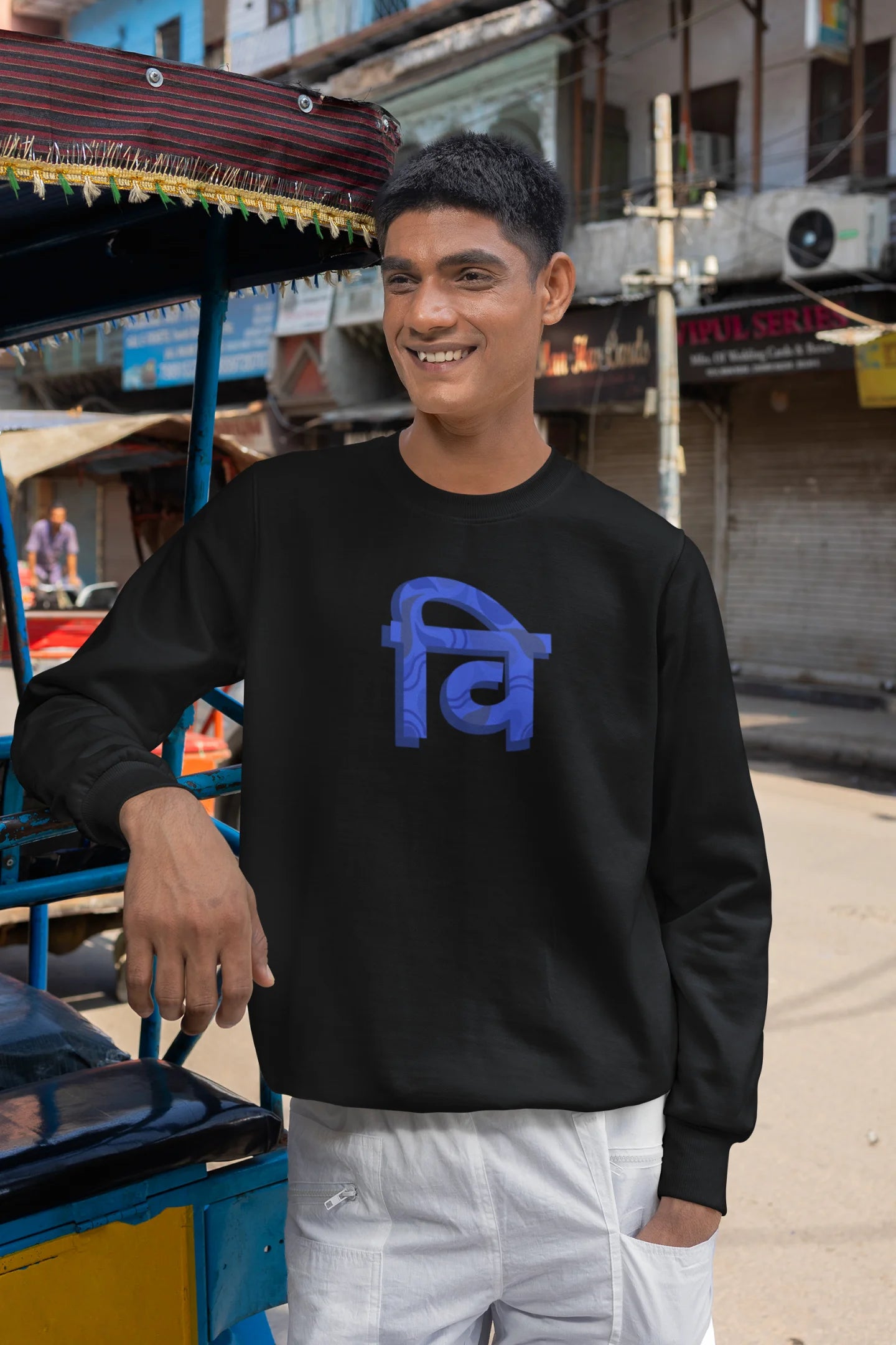 5th front view of a male model wearing a black sweatshirt with the phrase "Vichitra Pranee" (meaning "Strange being" or "alien") in a stylish Hindi font.