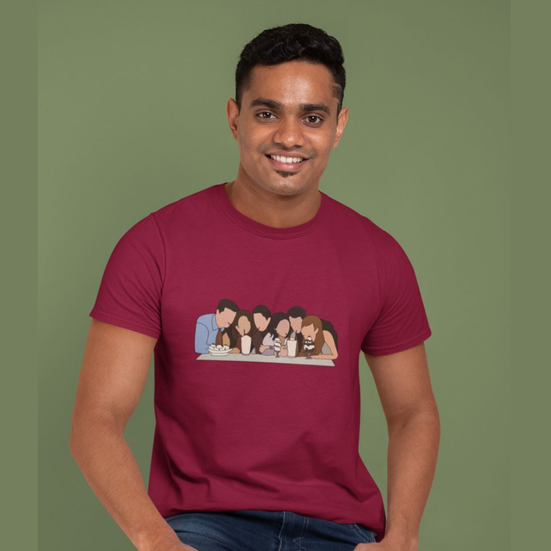 Front view of a male model wearing a maroon casual tee with Friends TV show inspired design featuring the central perk crew.