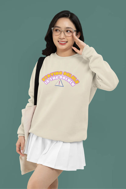 4th front view of female model wearing a cream sweatshirt with the hilarious message "Stay Delulu" in a bold design. Ideal for those who love trendy slang and lighthearted humor.