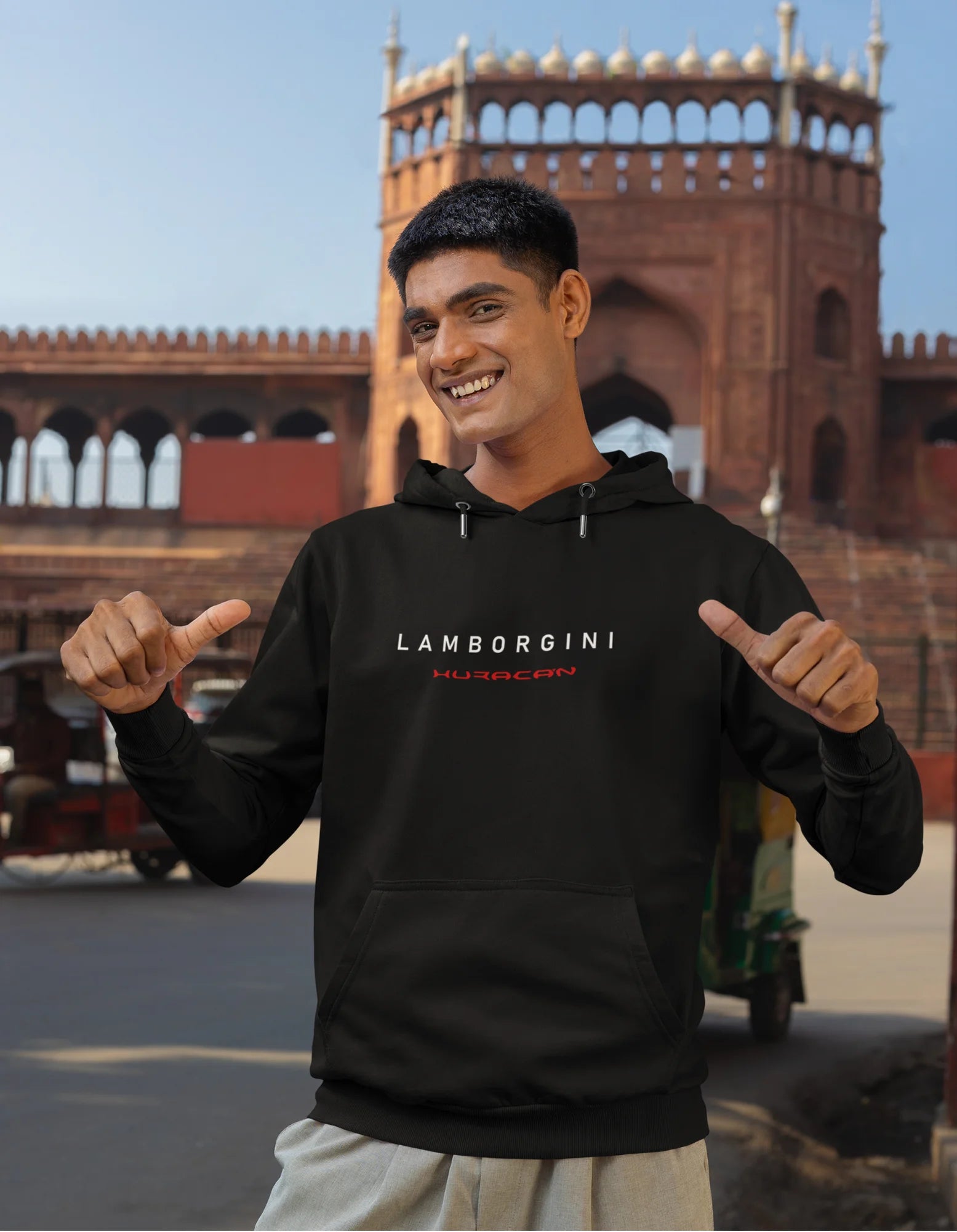 Third front view of a male model wearing a black hoodie featuring a Lamborghini Huracan design, exuding speed and power.