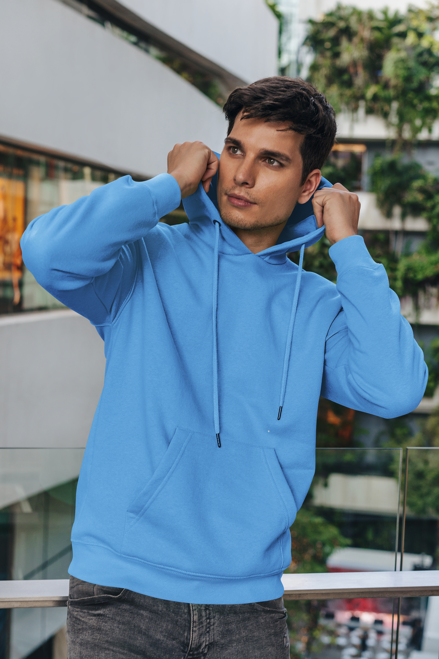 Front view of a male model wearing a sky blue premium quality, pure cotton hoodie.