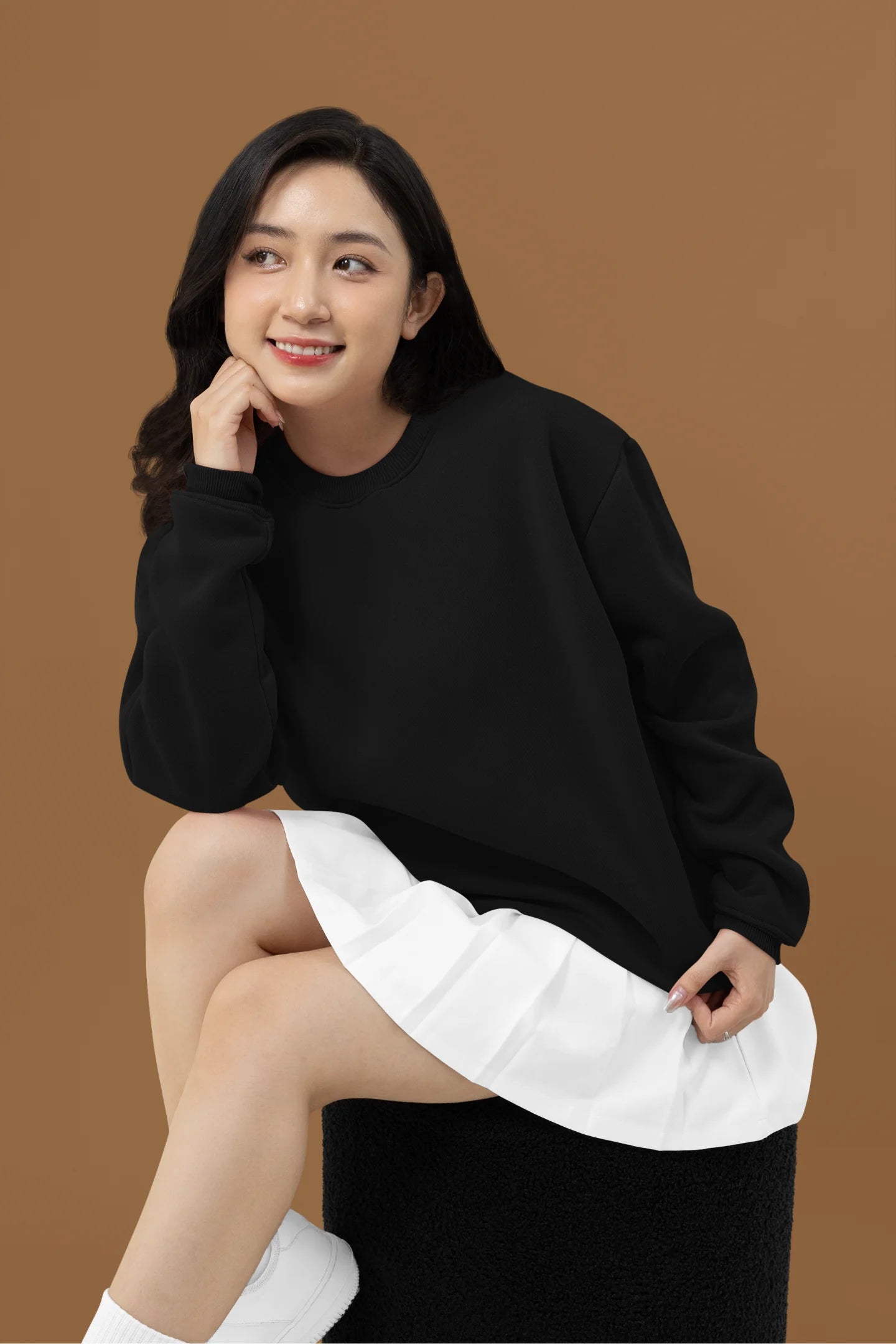2nd front view of a female model wearing a black sweatshirt featuring a beautiful rose design with inspirational text, offering a calming and uplifting aesthetic.