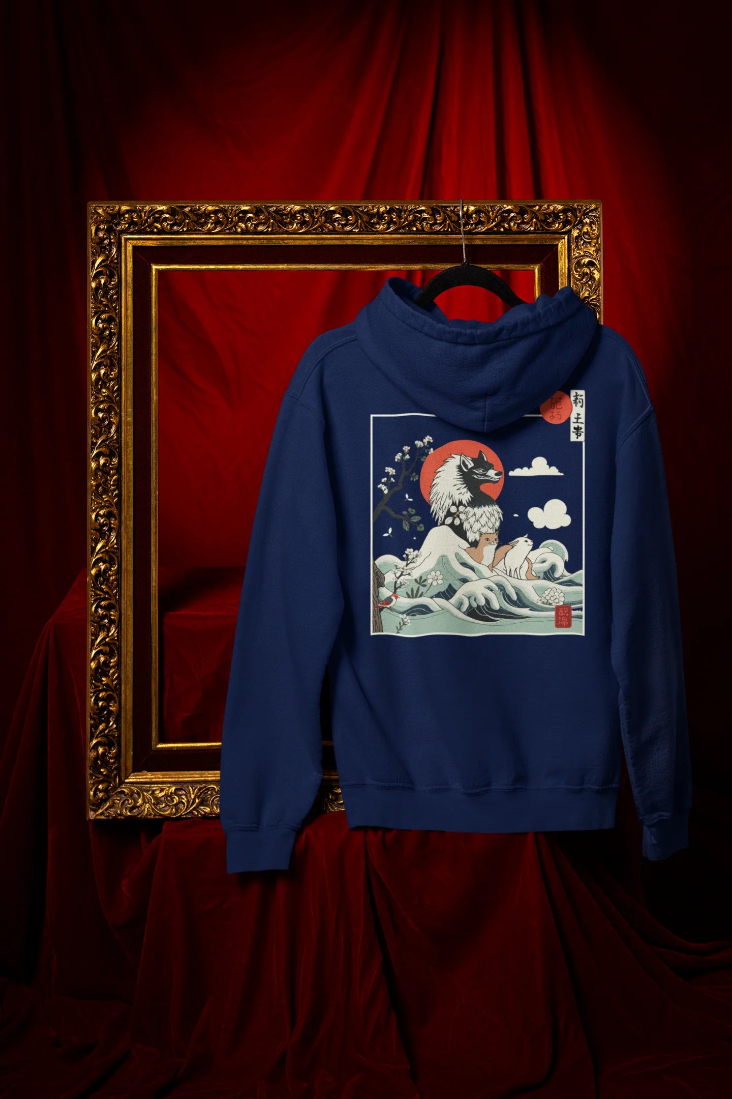 Back view of a navy blue hoodie with a design of a wolf surveying a Japanese landscape.
