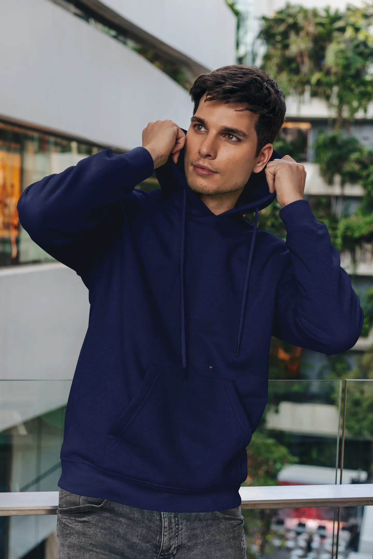 Front view of a male model wearing a navy blue premium quality, pure cotton hoodie.