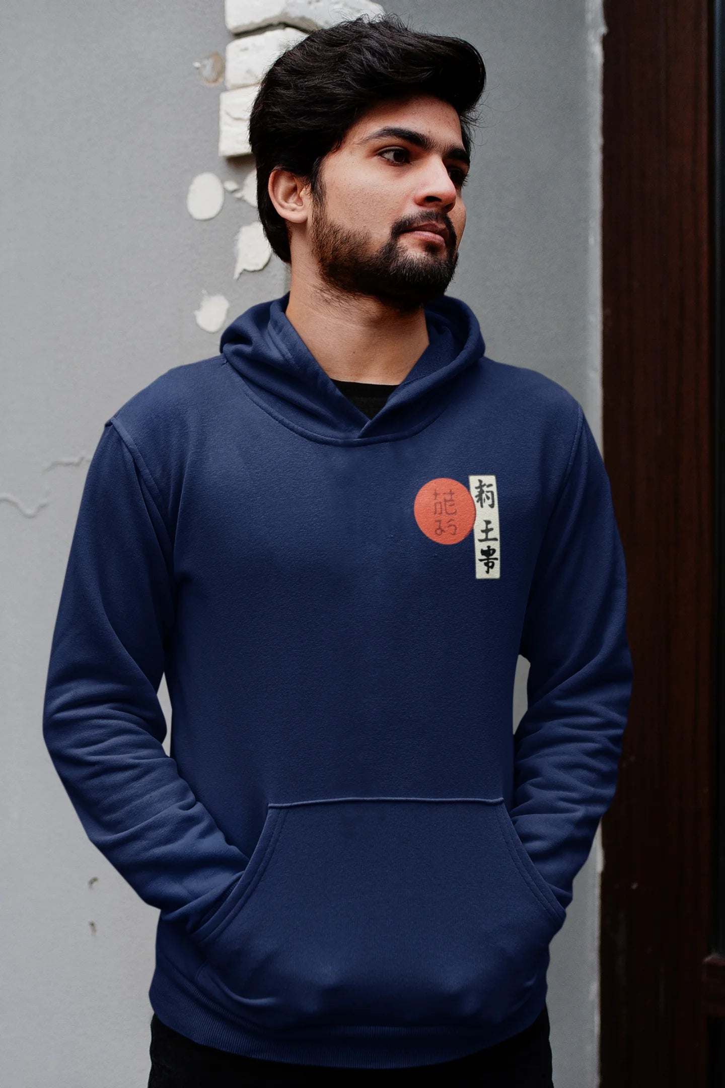 First front view of a male model wearing a navy blue hoodie with a design of a wolf surveying a Japanese landscape.