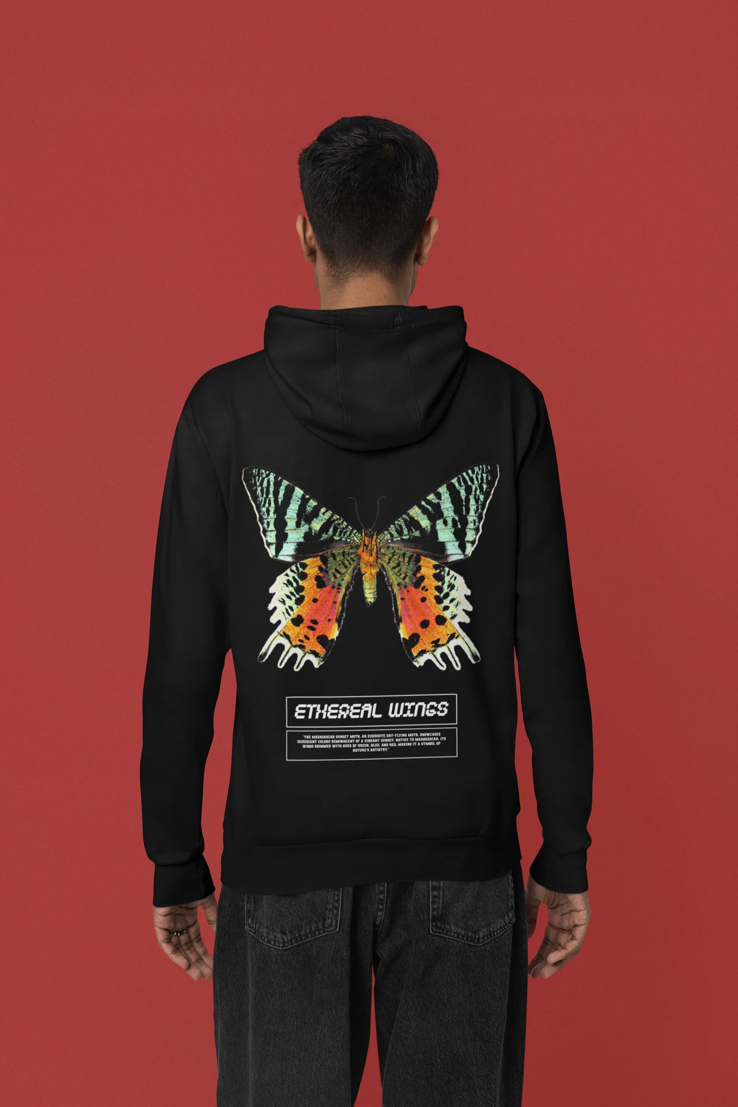 Back view of a male model wearing a black hoodie with a glowing butterfly design, symbolizing the ethereal beauty of nature.