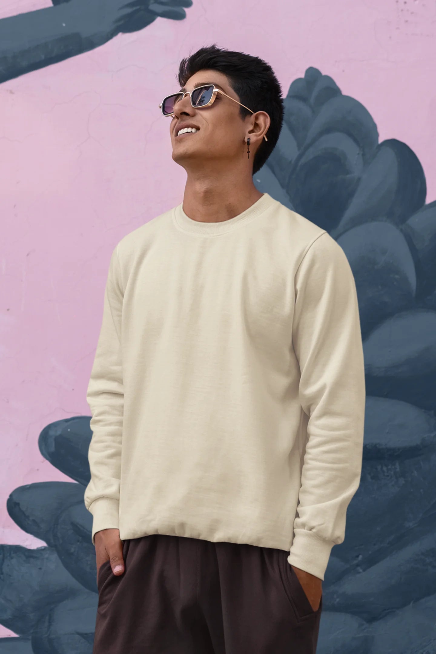 First front view of male model wearing a cream F.R.I.E.N.D.S. sweatshirt featuring a design inspired by Joey Tribbiani's funny quotes and signature charm.