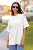 Front view of female model wearing a off-white oversized F.R.I.E.N.D.S. t-shirt featuring a design inspired by Joey Tribbiani's funny quotes and signature charm.