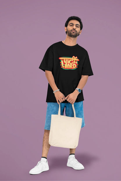 2nd front view of a male model wearing a black oversized t-shirt with the phrase "Party Hard" in an energetic Hindi.