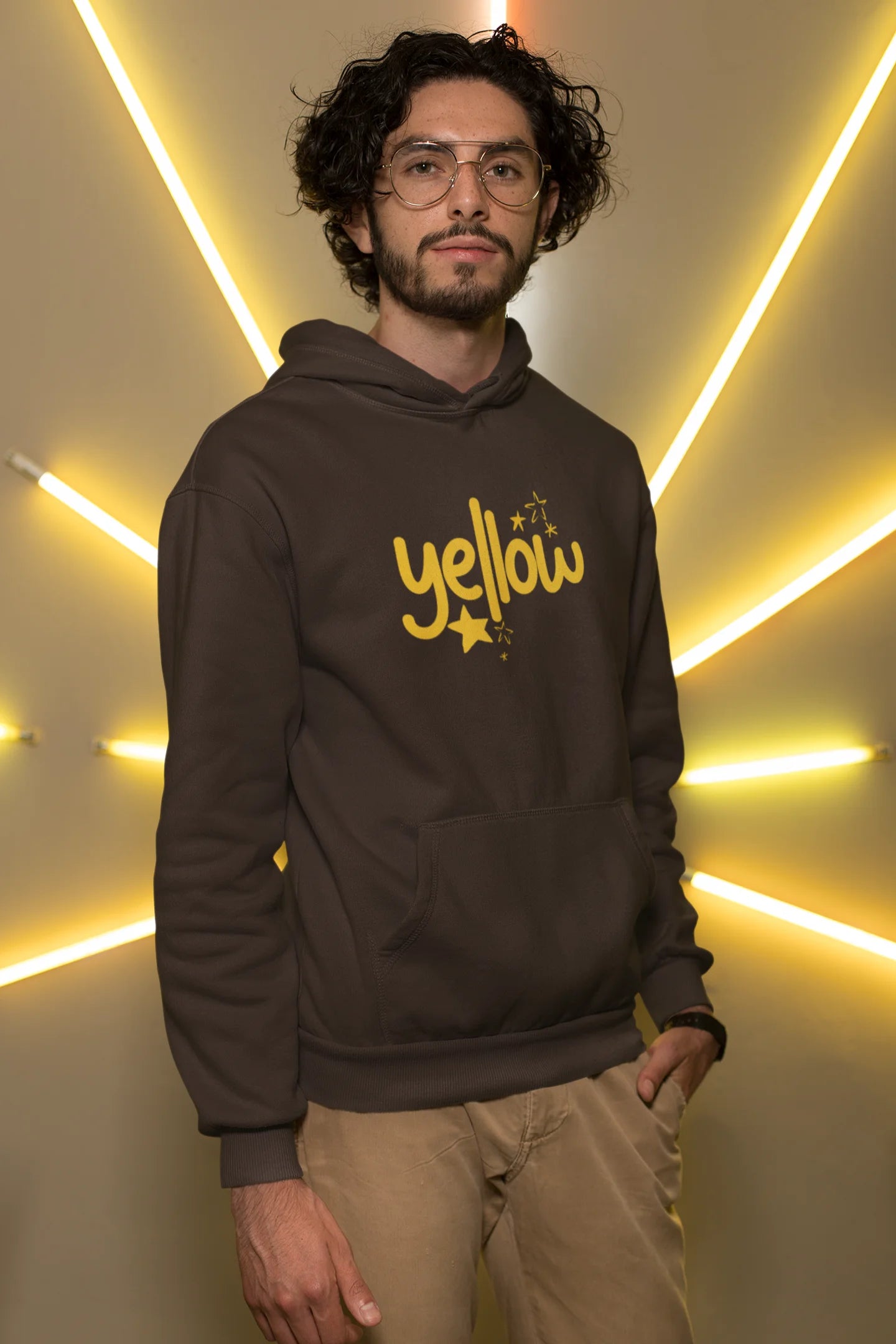 3rd front view of a male model wearing a chocolate brown hoodie with the "Yellow" album artwork by Coldplay.