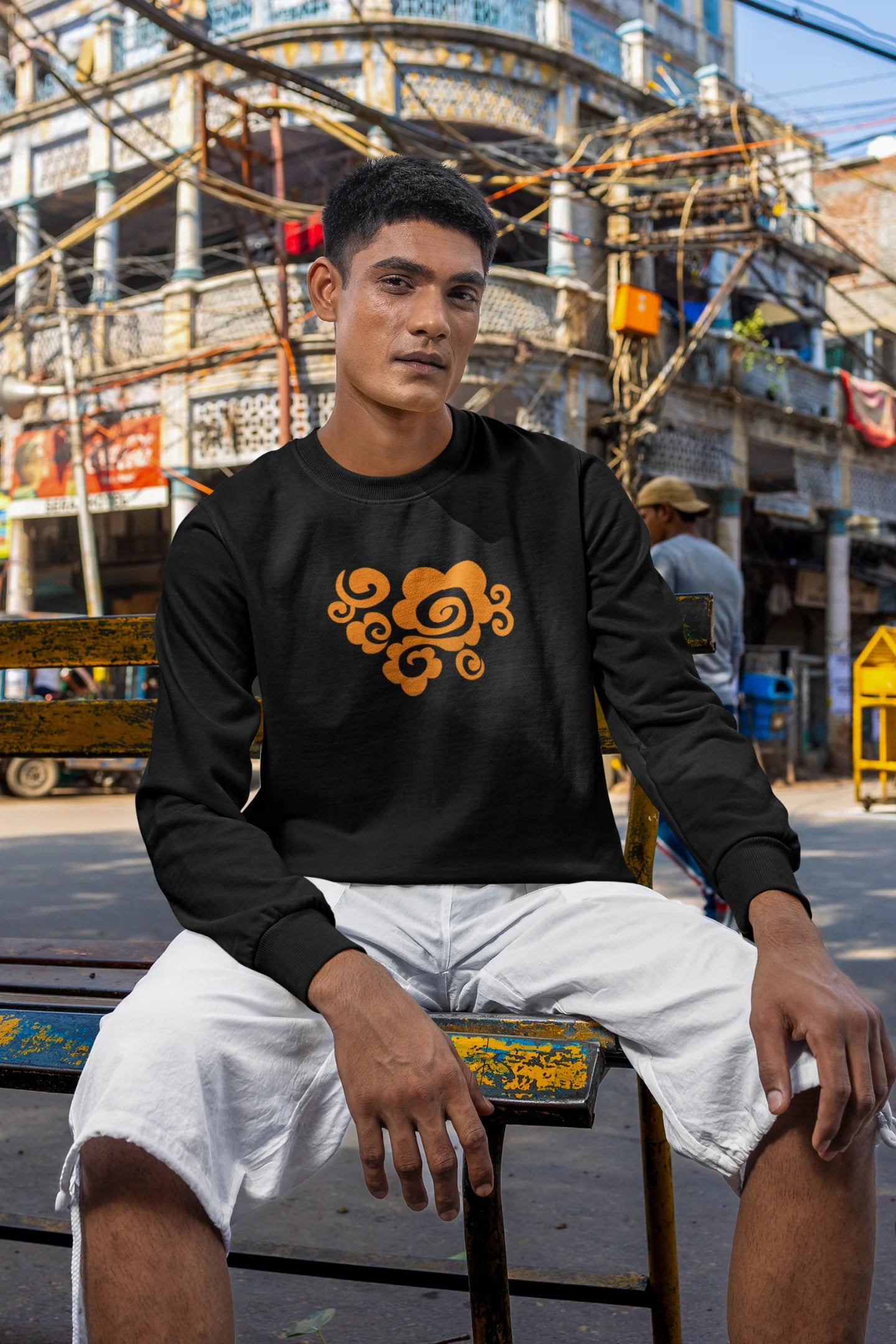 2nd front view of a male model wearing a black sweatshirt featuring "Bindass" in a stylish Hindi font.